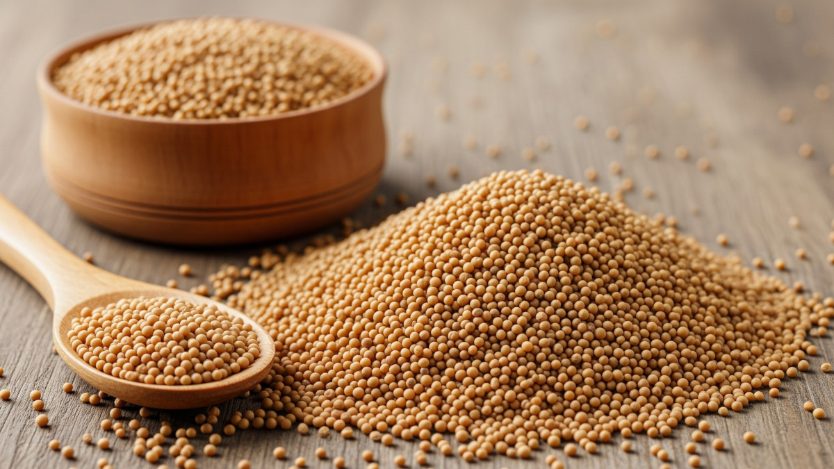 Table with mustard seeds, bowl, and spoon, illustrating mustard seeds benefits for health.