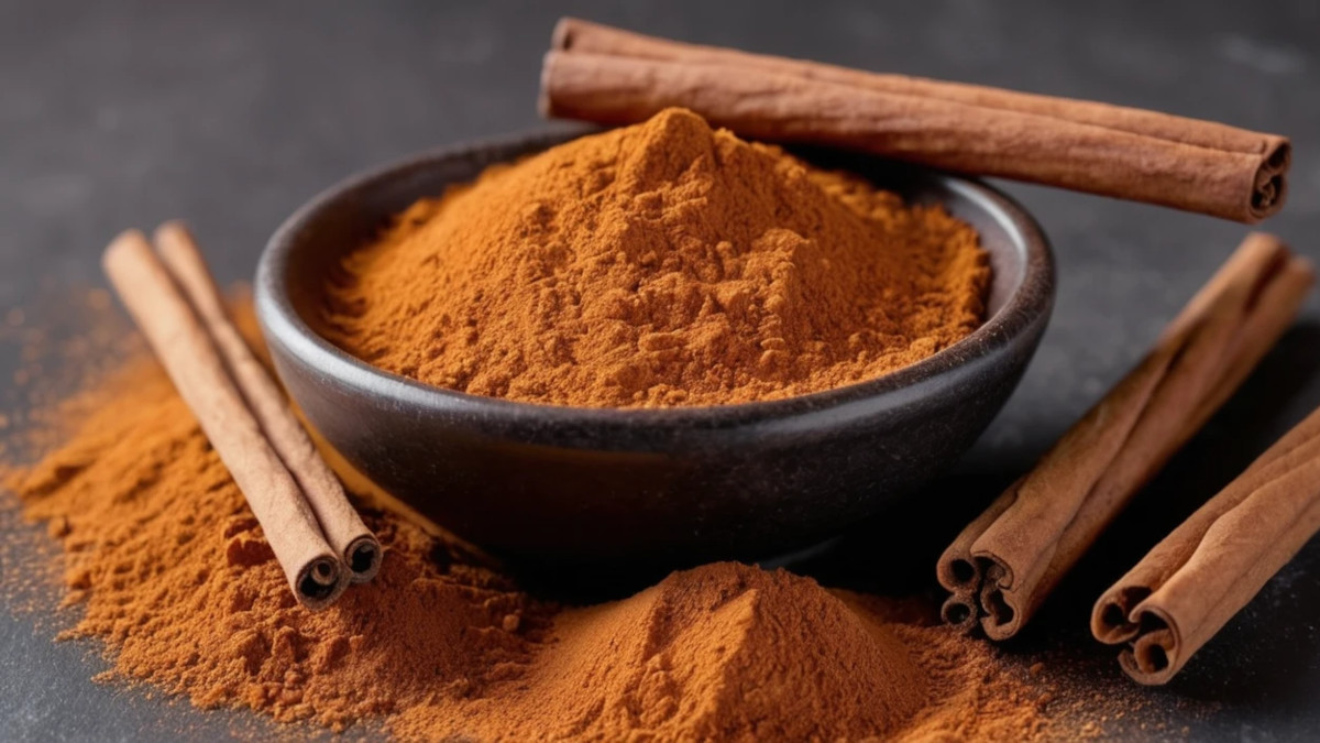 Close-up of cinnamon powder with cinnamon sticks scattered around it, representing different types of cinnamon.